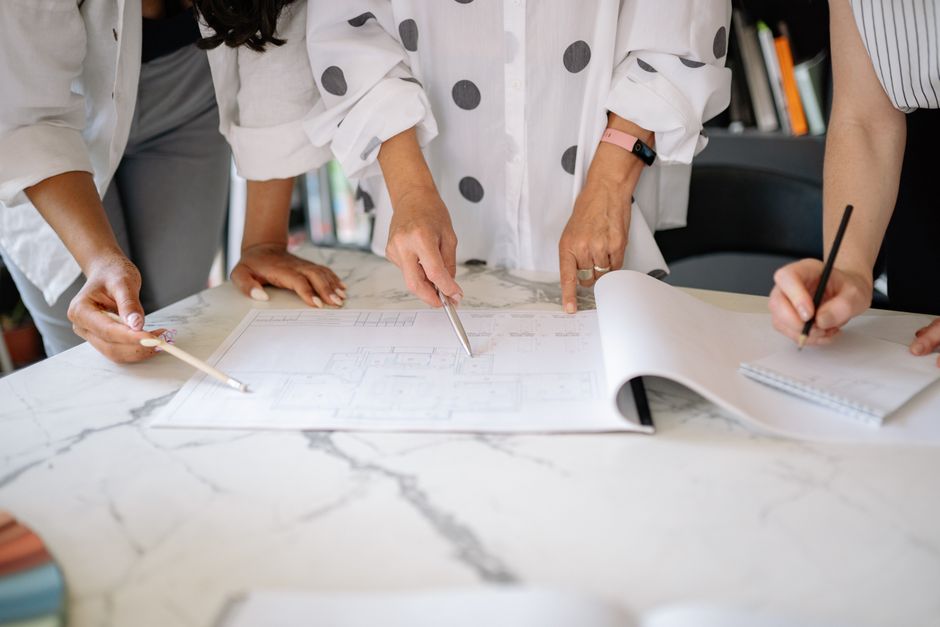 Professionals reviewing financial graphs and charts during a meeting.